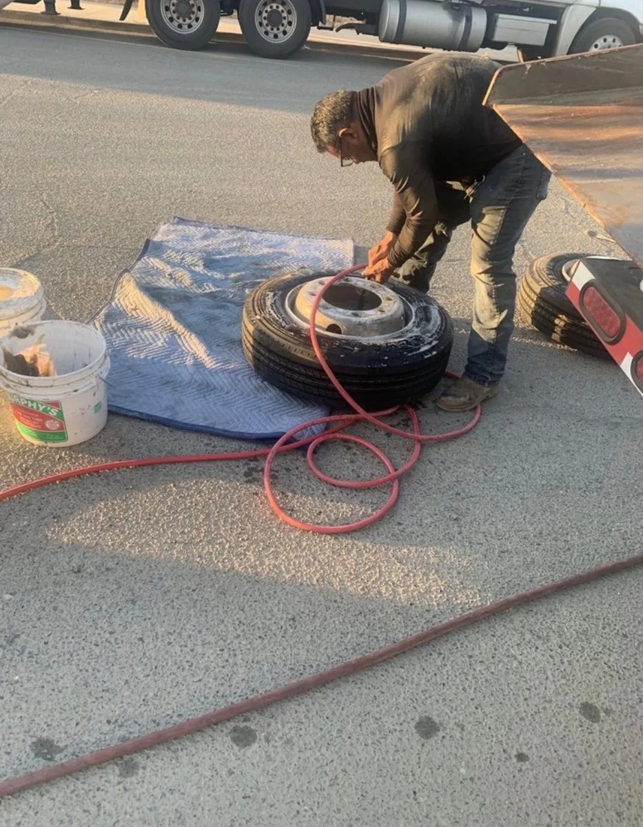 Commercial truck tire being serviced on location